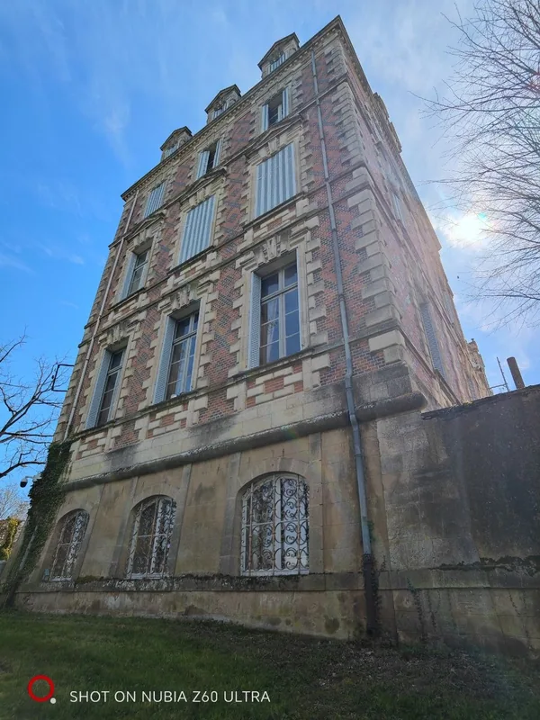 The pavilion with the sun breaking over its roofline