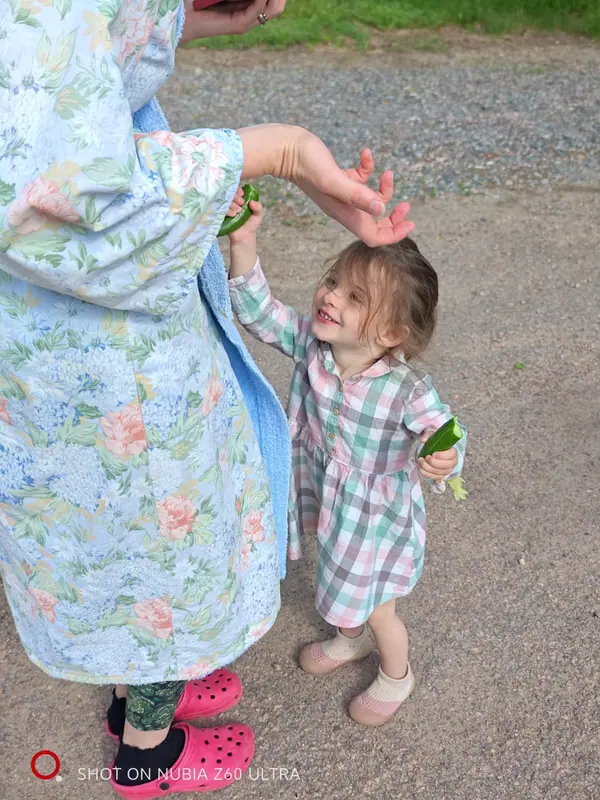 A mother and her daughter laughing together outdoors