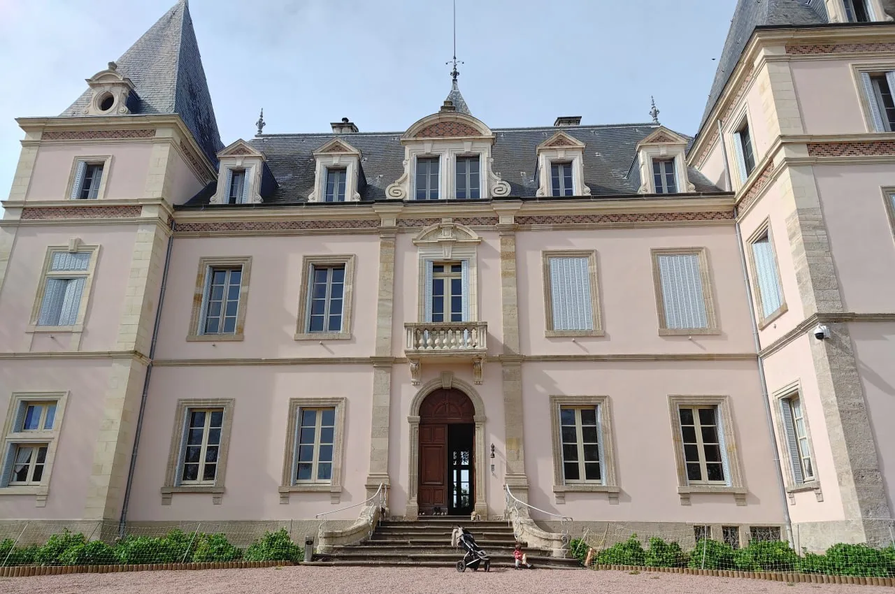 The chateau frontage, clean and symmetrical, from the drive