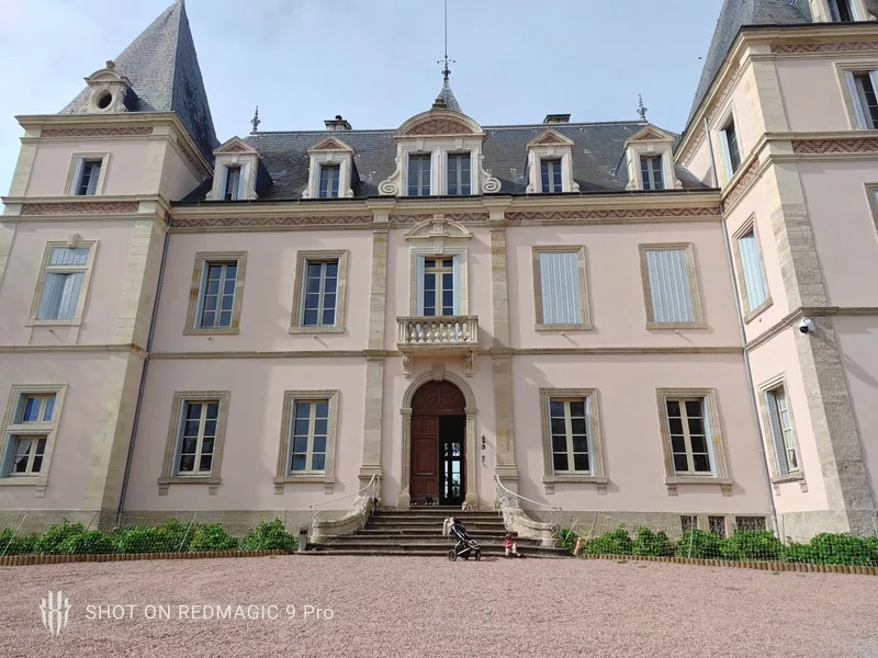 The chateau frontage, clean and symmetrical, from the drive