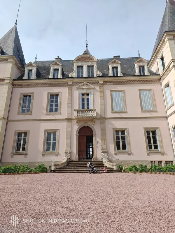 The symmetrical front entrance with its stone staircase and arched double doors