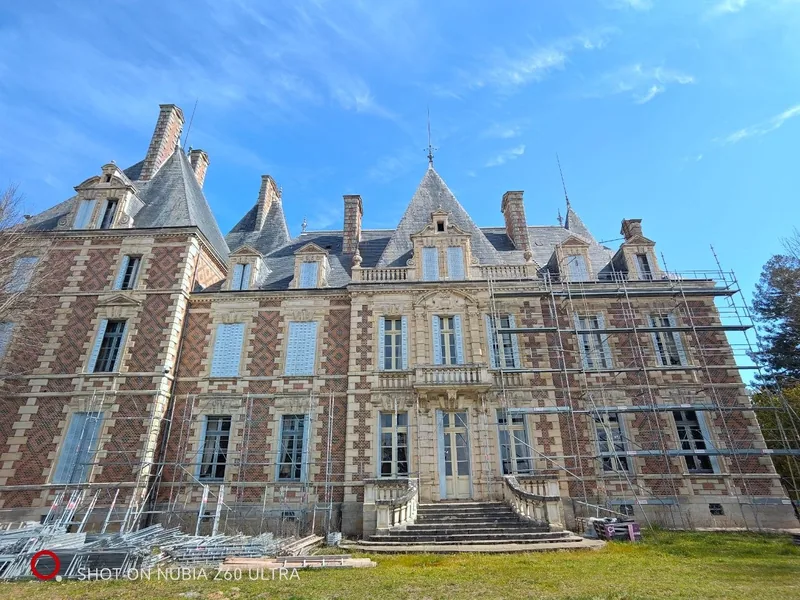 Wide view of the full frontage beneath a deep blue sky
